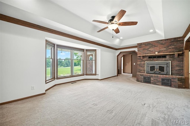 20731 Columbine Dr, Warrenton, MO 63383 - unfurnished living room featuring carpet flooring, ceiling fan, recessed lighting, a tray ceiling, and arched walkways