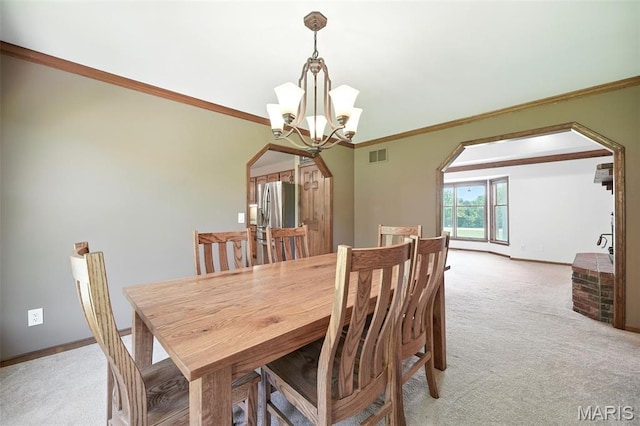 20731 Columbine Dr, Warrenton, MO 63383 - dining room with arched walkways, light carpet, a chandelier, and crown molding