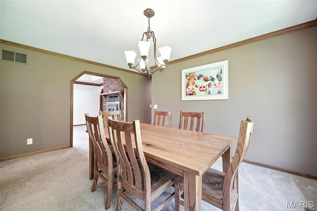 20731 Columbine Dr, Warrenton, MO 63383 - dining area with arched walkways, light colored carpet, a chandelier, and ornamental molding