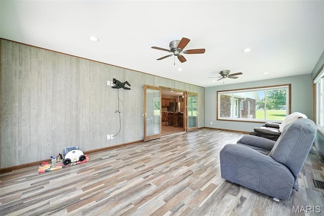 20731 Columbine Dr, Warrenton, MO 63383 - living room with wood walls, wood finished floors, ceiling fan, and recessed lighting