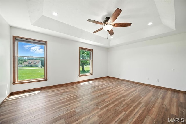 20731 Columbine Dr, Warrenton, MO 63383 - spare room with a raised ceiling, light wood-style floors, ceiling fan, and recessed lighting