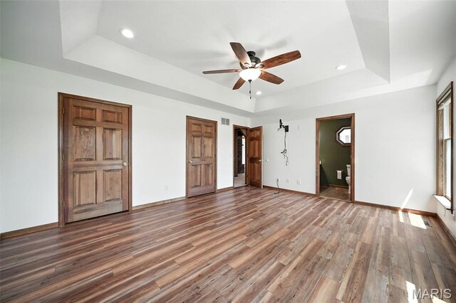 20731 Columbine Dr, Warrenton, MO 63383 - unfurnished bedroom with a raised ceiling, recessed lighting, wood finished floors, ensuite bathroom, and ceiling fan