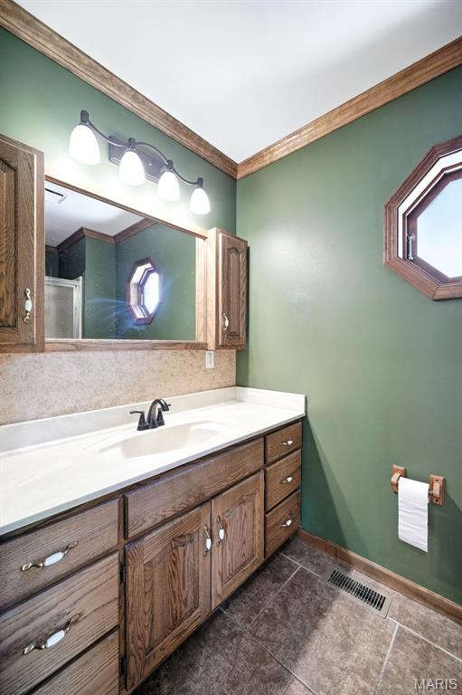 20731 Columbine Dr, Warrenton, MO 63383 - bathroom featuring vanity, crown molding, and tile patterned flooring