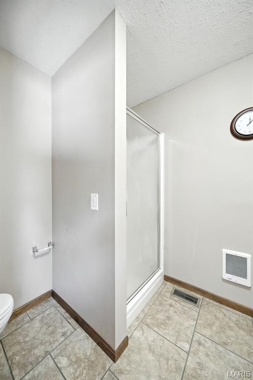 20731 Columbine Dr, Warrenton, MO 63383 - bathroom featuring a stall shower, tile patterned flooring, and a textured ceiling