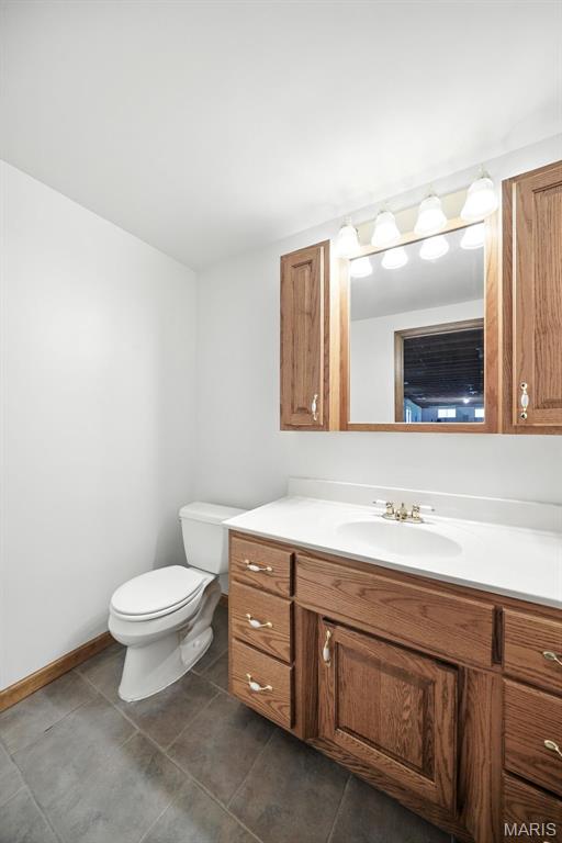 20731 Columbine Dr, Warrenton, MO 63383 - half bathroom with vanity and tile patterned flooring