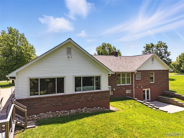 20731 Columbine Dr, Warrenton, MO 63383 - back of house with brick siding, a chimney, a lawn, and a shingled roof