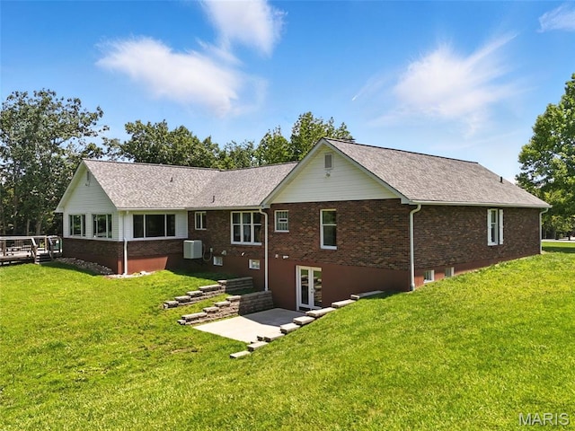 20731 Columbine Dr, Warrenton, MO 63383 - back of house featuring a lawn, brick siding, and a patio area
