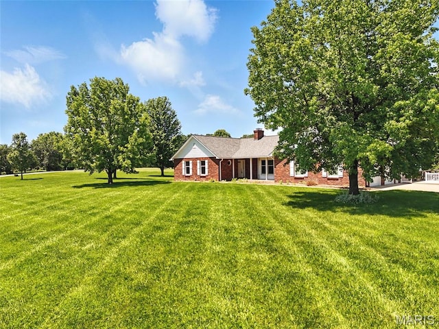 20731 Columbine Dr, Warrenton, MO 63383 - view of front of home with a front lawn, brick siding, and a chimney