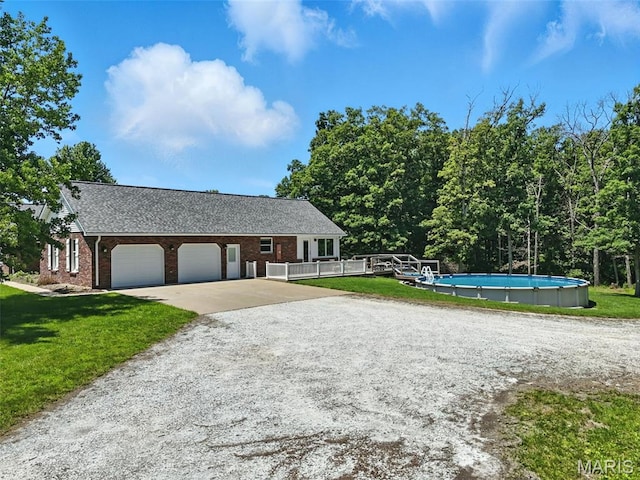 20731 Columbine Dr, Warrenton, MO 63383 - view of front of home with concrete driveway, an attached garage, a front lawn, and brick siding