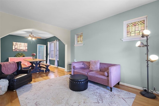 4444 Taft Ave, Saint Louis, MO 63116 - living area with arched walkways, wood finished floors, ceiling fan, and baseboards