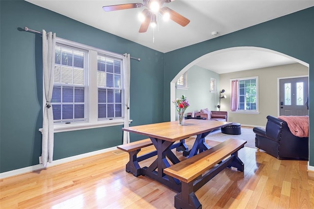 4444 Taft Ave, Saint Louis, MO 63116 - dining space featuring arched walkways, light wood-type flooring, and ceiling fan
