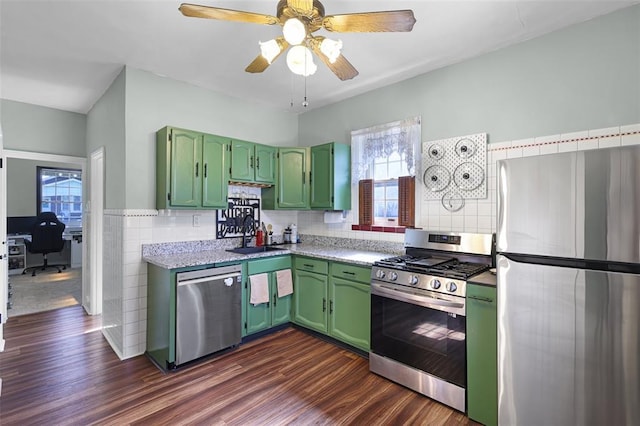 4444 Taft Ave, Saint Louis, MO 63116 - kitchen with appliances with stainless steel finishes, green cabinetry, an office area, dark wood-style floors, and tile walls
