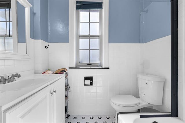 4444 Taft Ave, Saint Louis, MO 63116 - bathroom with tile walls, toilet, vanity, and wainscoting