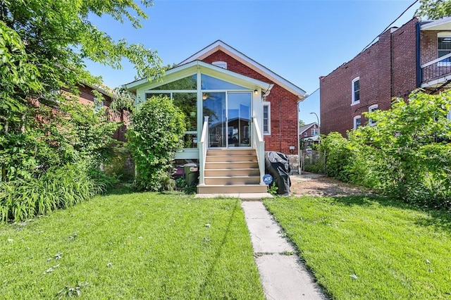 4444 Taft Ave, Saint Louis, MO 63116 - view of front facade featuring a sunroom and brick siding