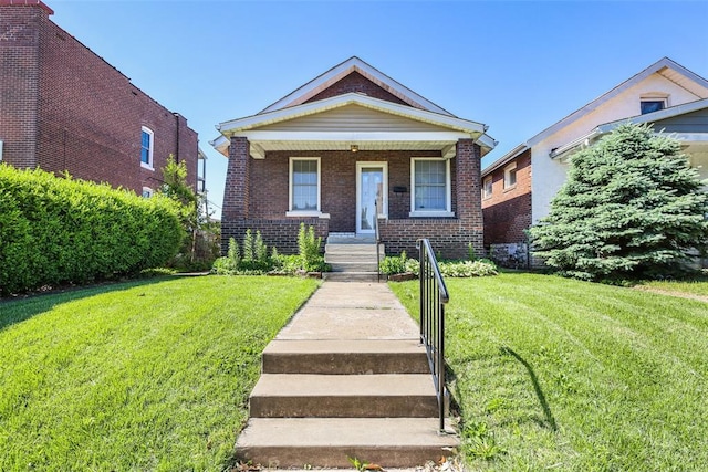 4444 Taft Ave, Saint Louis, MO 63116 - view of front of home featuring brick siding, a front yard, and a porch