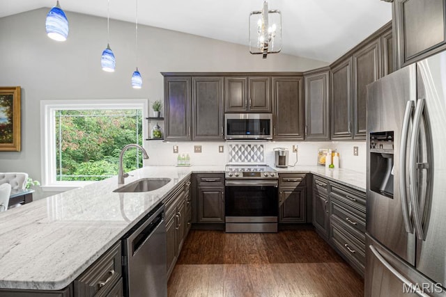 1042 Windsor Crest Ct, Saint Peters, MO 63376 - kitchen with stainless steel appliances, vaulted ceiling, a sink, a peninsula, and dark brown cabinetry