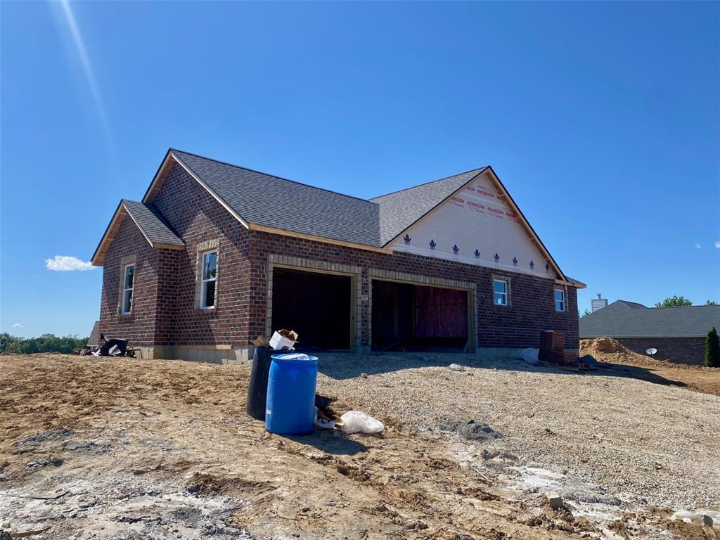 397 Arvel Ln, Washington, MO 63090 - view of side of property with an attached garage, brick siding, and a shingled roof