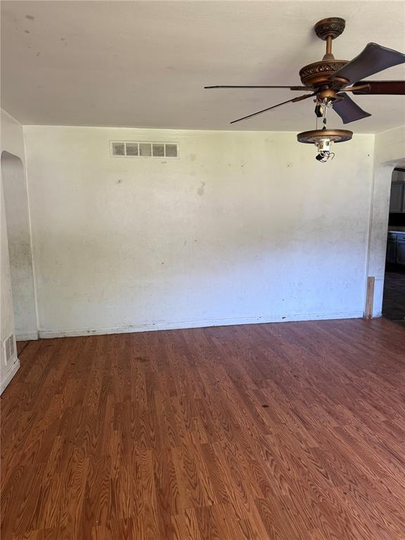 9915 N Rd, Fairview Heights, IL 62208 - spare room featuring wood finished floors, ceiling fan, and arched walkways