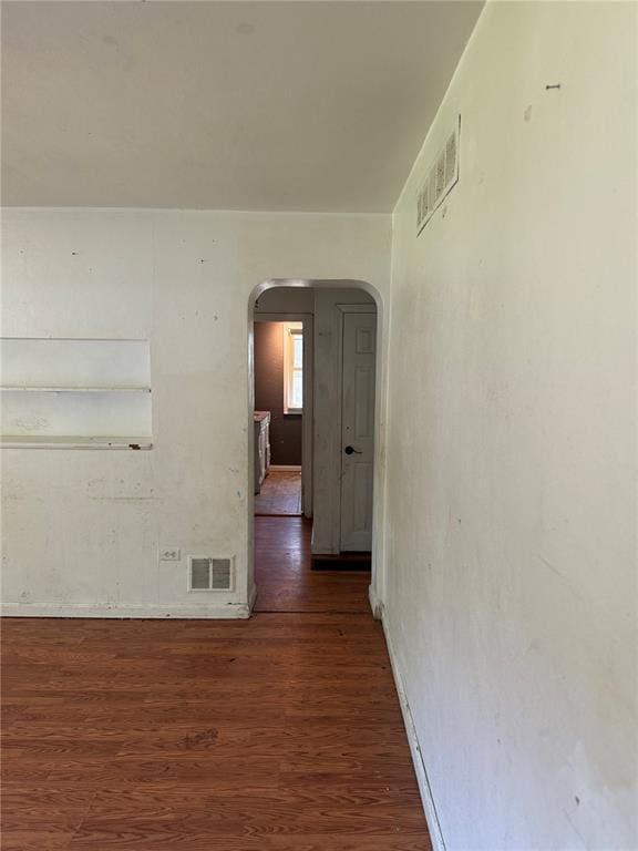 9915 N Rd, Fairview Heights, IL 62208 - hallway with arched walkways and dark wood-style flooring