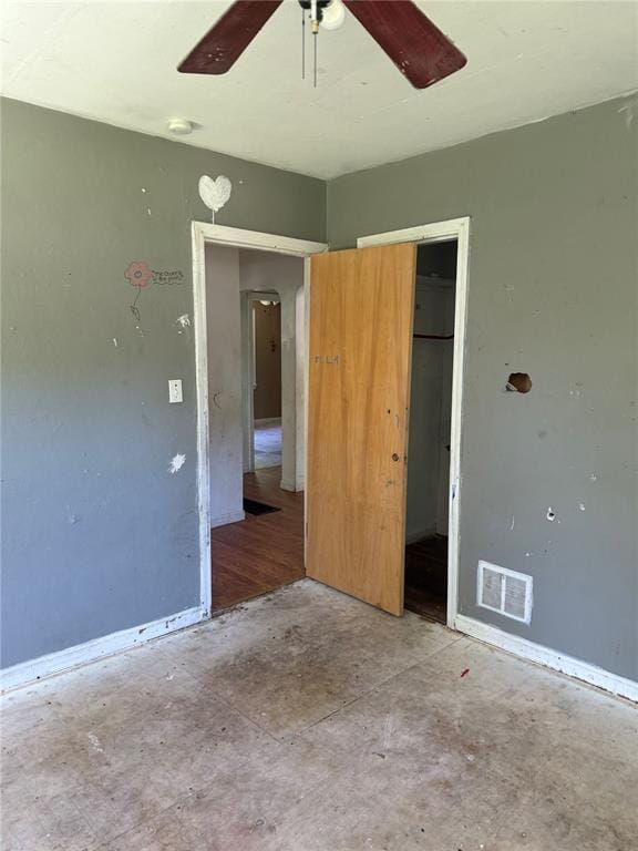 9915 N Rd, Fairview Heights, IL 62208 - unfurnished bedroom featuring unfinished concrete flooring, a ceiling fan, and a closet