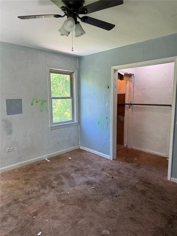 9915 N Rd, Fairview Heights, IL 62208 - unfurnished bedroom featuring carpet floors, baseboards, and a ceiling fan
