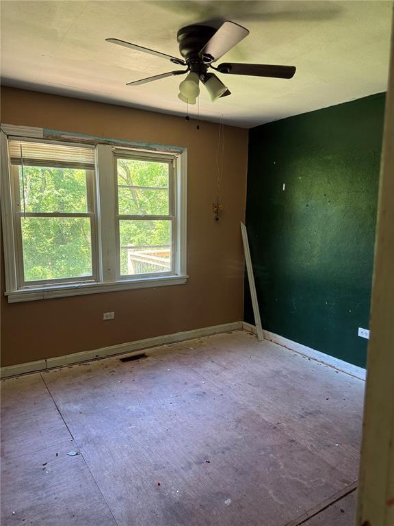 9915 N Rd, Fairview Heights, IL 62208 - empty room with baseboards and a ceiling fan
