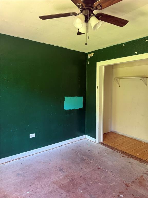9915 N Rd, Fairview Heights, IL 62208 - unfurnished bedroom featuring a closet, baseboards, and a ceiling fan