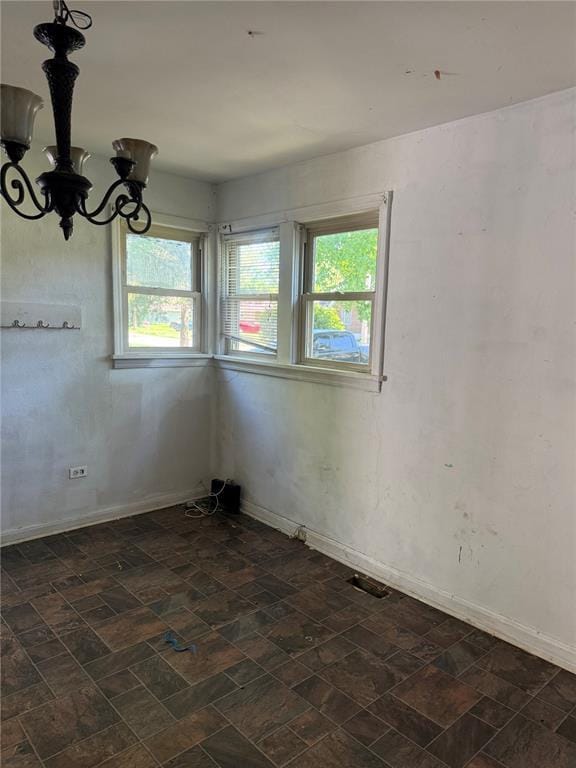 9915 N Rd, Fairview Heights, IL 62208 - empty room featuring a chandelier, plenty of natural light, and baseboards