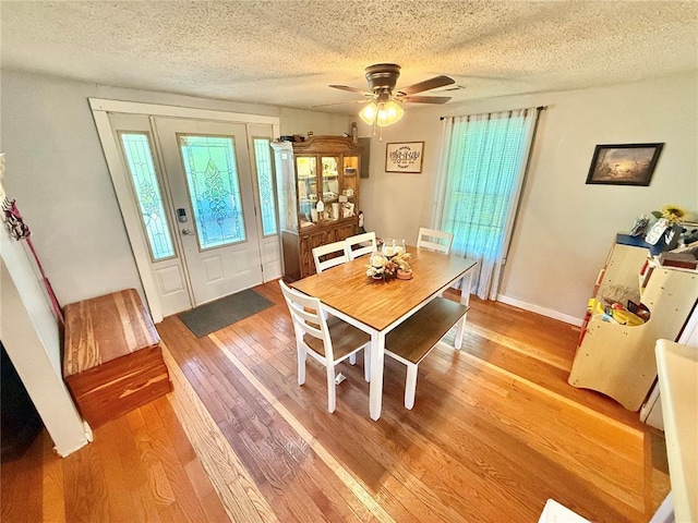 723 Ada St, Bismarck, MO 63624 - dining space with light wood finished floors, a textured ceiling, and ceiling fan