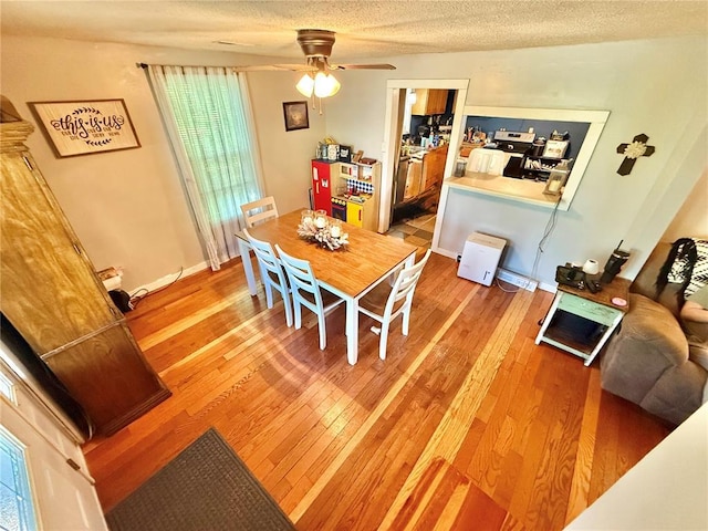 723 Ada St, Bismarck, MO 63624 - dining area featuring ceiling fan, light wood-type flooring, and a textured ceiling