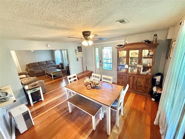 723 Ada St, Bismarck, MO 63624 - dining area with a textured ceiling, a ceiling fan, and light wood-style flooring