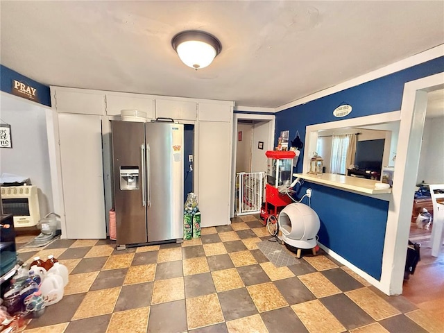 723 Ada St, Bismarck, MO 63624 - kitchen with stainless steel refrigerator with ice dispenser, white cabinets, and light countertops