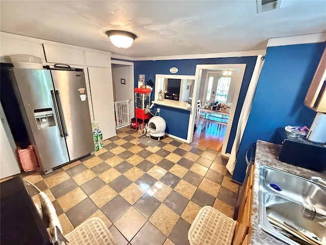 723 Ada St, Bismarck, MO 63624 - kitchen featuring stainless steel refrigerator with ice dispenser, light countertops, white cabinets, and a sink