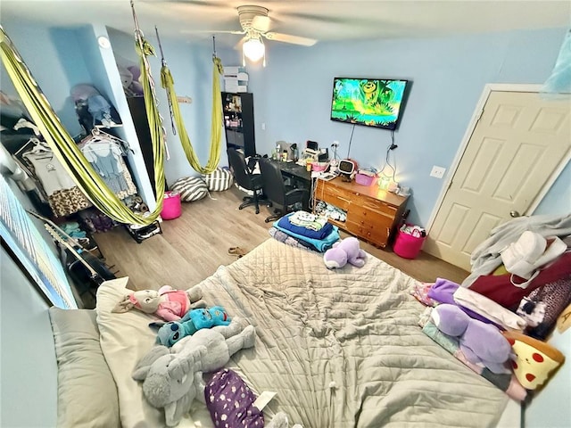 723 Ada St, Bismarck, MO 63624 - bedroom with wood finished floors, a desk, and a ceiling fan