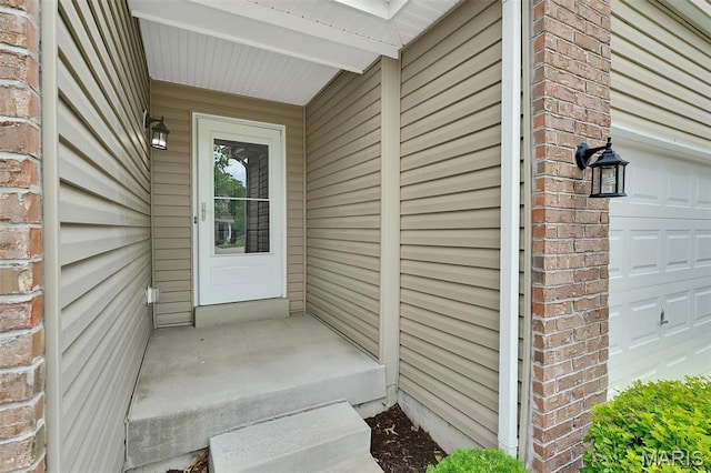 32 Loris Ln, Saint Charles, MO 63303 - property entrance featuring a garage and brick siding