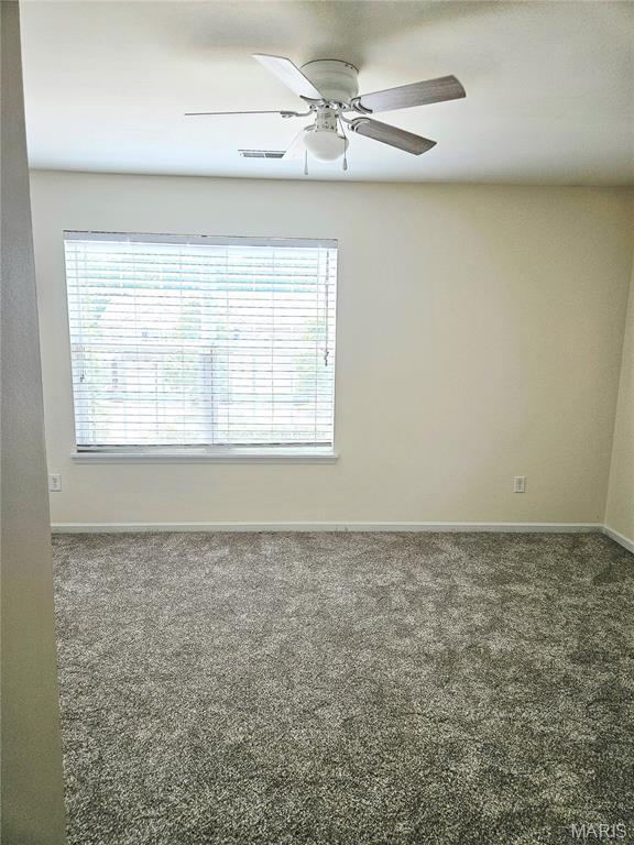 32 Loris Ln, Saint Charles, MO 63303 - carpeted empty room with baseboards and ceiling fan