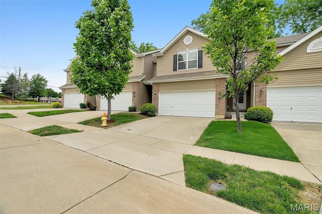 32 Loris Ln, Saint Charles, MO 63303 - traditional-style house with driveway, brick siding, an attached garage, and a front yard