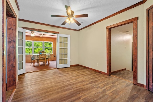 9268 Pin Oak Rd, Edwardsville, IL 62025 - spare room featuring wood finished floors, a ceiling fan, french doors, a textured ceiling, and baseboards