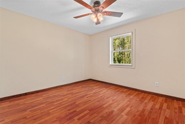 9268 Pin Oak Rd, Edwardsville, IL 62025 - empty room with light wood-style flooring, ceiling fan, baseboards, and a textured ceiling