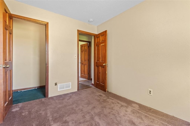 9268 Pin Oak Rd, Edwardsville, IL 62025 - unfurnished bedroom featuring carpet floors, a closet, and a textured ceiling