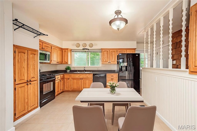 1968 Centurion Dr, Fenton, MO 63026 - kitchen featuring black appliances, backsplash, a sink, and dark countertops
