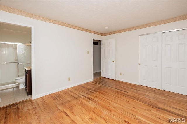 1968 Centurion Dr, Fenton, MO 63026 - unfurnished bedroom with light wood-style flooring, baseboards, a closet, and connected bathroom