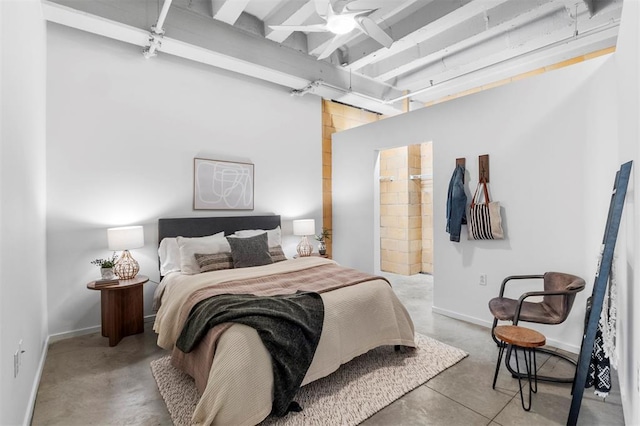 1720 Chouteau Ave Unit 303, Saint Louis, MO 63103 - bedroom featuring finished concrete floors, beamed ceiling, baseboards, and ensuite bathroom