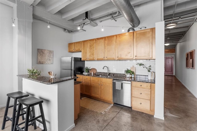 1720 Chouteau Ave Unit 303, Saint Louis, MO 63103 - kitchen with appliances with stainless steel finishes, finished concrete floors, backsplash, a kitchen breakfast bar, and a sink