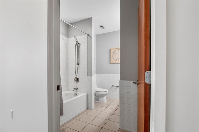 1720 Chouteau Ave Unit 303, Saint Louis, MO 63103 - bathroom featuring toilet, tile patterned floors, tub / shower combination, tile walls, and wainscoting