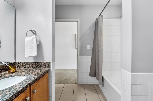 1720 Chouteau Ave Unit 303, Saint Louis, MO 63103 - full bath featuring vanity, tile patterned flooring, and shower / bathtub combination with curtain