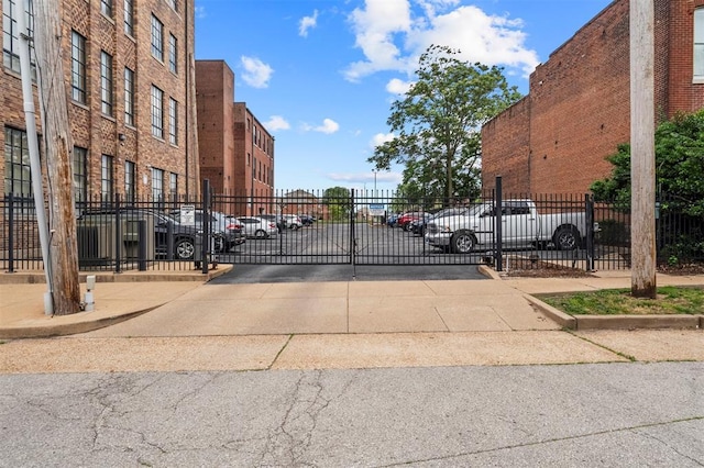 1720 Chouteau Ave Unit 303, Saint Louis, MO 63103 - view of concrete road with a gated entry, curbs, and a gate