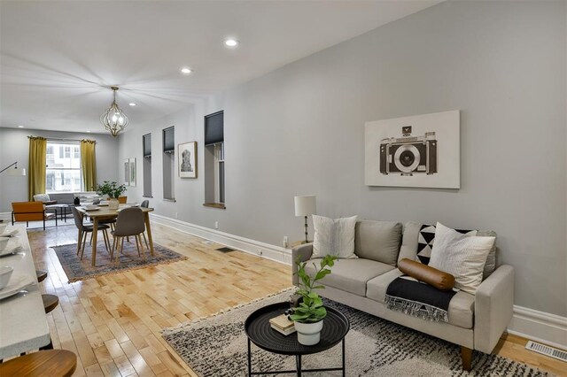 4412 Chouteau, Saint Louis, MO 63110 - living room with a chandelier, wood finished floors, recessed lighting, and baseboards