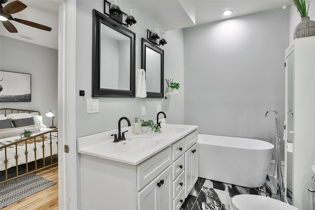 4412 Chouteau, Saint Louis, MO 63110 - bathroom with ceiling fan, a freestanding bath, double vanity, and recessed lighting