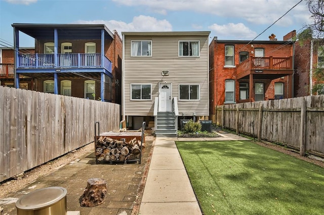 4412 Chouteau, Saint Louis, MO 63110 - back of property featuring an outdoor fire pit, entry steps, and cooling unit